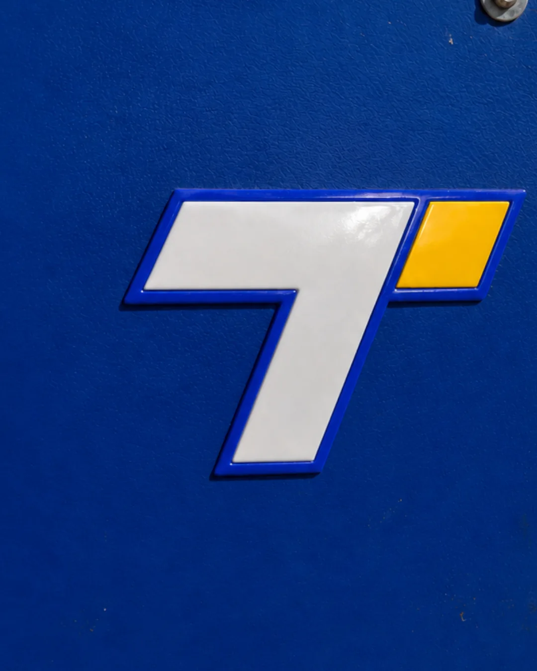 Seven mark raised in vinyl on azul equipment panel